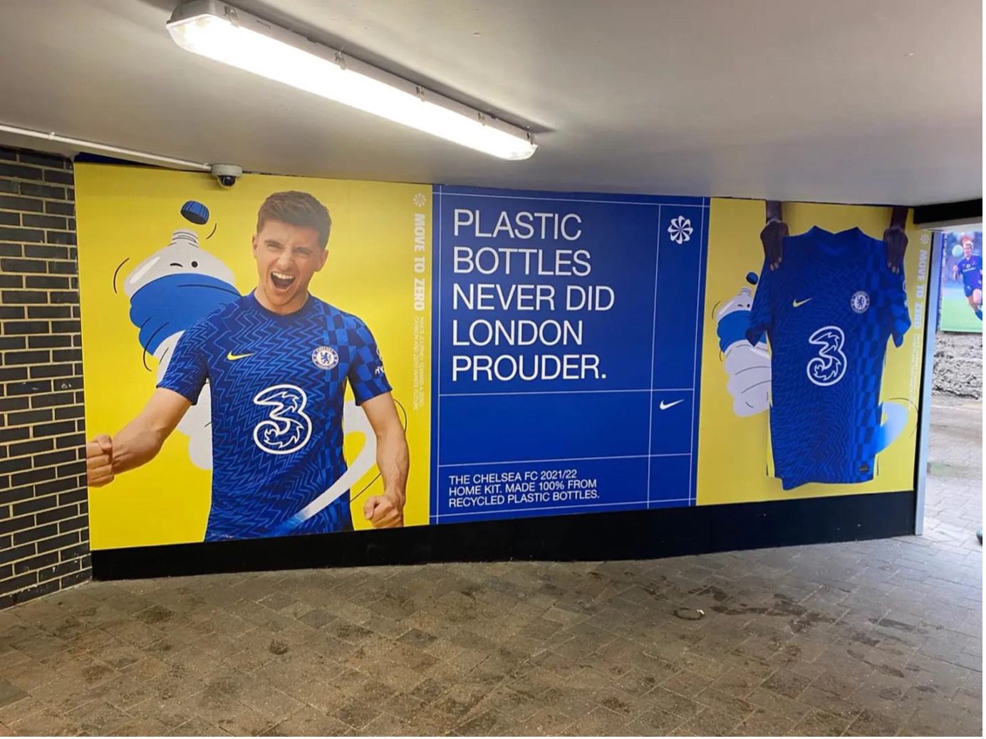 Yellow and blue signage with a sportsman and text that reads "plastic bottles never did London prouder"